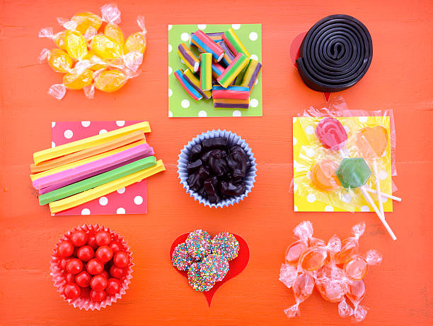 istock Bright colorful candy on orange wood background. 489926910