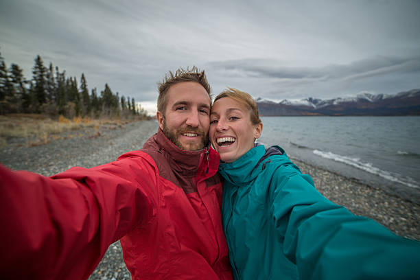 istock Cheerful couple taking selfie portrait in nature 489927810