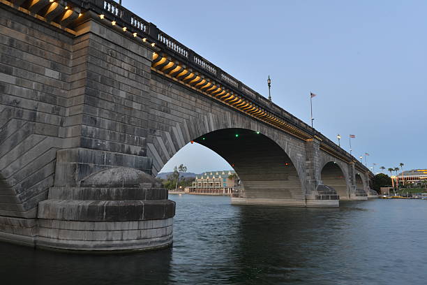 London Bridge is a bridge in Lake Havasu City, Arizona, United States. It is a relocated 1831 bridge that formerly spanned the River Thames in London, England, until it was dismantled in 1967. The Arizona bridge is a reinforced concrete structure clad in the original masonry of the 1830s bridge, which was bought by Robert P. McCulloch from the City of London. McCulloch had exterior granite blocks from the original bridge numbered and transported to America to construct the present bridge in Lake Havasu City, a planned community he established in 1964 on the shore of Lake Havasu. The bridge was completed in 1971 (along with a canal), and links an island in the Colorado River with the main part of Lake Havasu City.