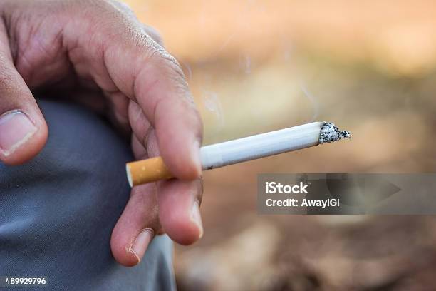 Smoking Cigarette Stock Photo - Download Image Now - 2015, Addiction, Adult