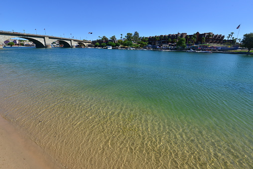 London Bridge is a bridge in Lake Havasu City, Arizona, United States. It is a relocated 1831 bridge that formerly spanned the River Thames in London, England, until it was dismantled in 1967. The Arizona bridge is a reinforced concrete structure clad in the original masonry of the 1830s bridge, which was bought by Robert P. McCulloch from the City of London. McCulloch had exterior granite blocks from the original bridge numbered and transported to America to construct the present bridge in Lake Havasu City, a planned community he established in 1964 on the shore of Lake Havasu. The bridge was completed in 1971 (along with a canal), and links an island in the Colorado River with the main part of Lake Havasu City.