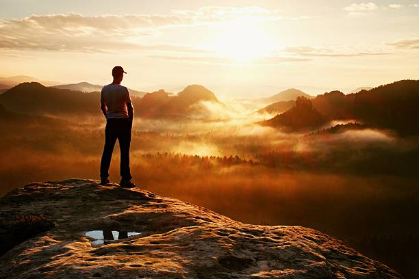 istock Alone hiker in shirt and red cap stand on peak 489931510