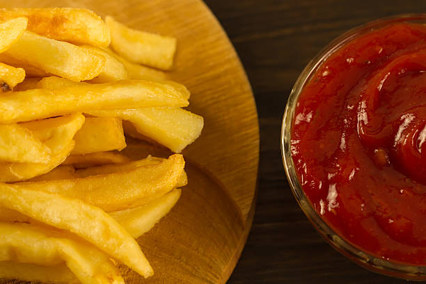 istock French  fries with fresh ketchup an old cutting Board 489931730