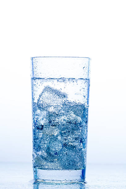 istock elegant glass with water and ice on a white background 489935684