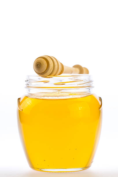 istock glass jar of fresh honey with drizzler 489936184