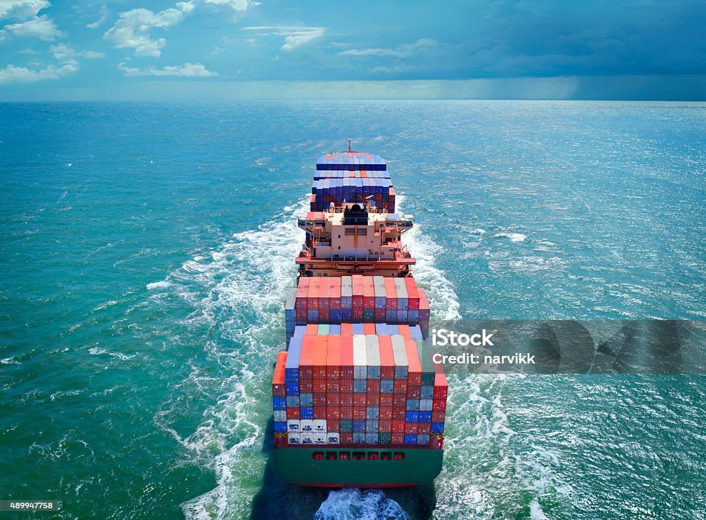 Aerial view of freight ship with cargo containers Aerial view of freight ship with cargo containers on the sea. See similar photos: :  http://www.oc-photo.net/FTP/icons/cargo.jpg Freight Transportation Stock Photo
