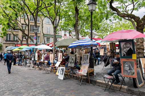Paris, France - May 28, 2015: Place du Tertre in Montmartre with street artists ready to paint tourists in Paris, France