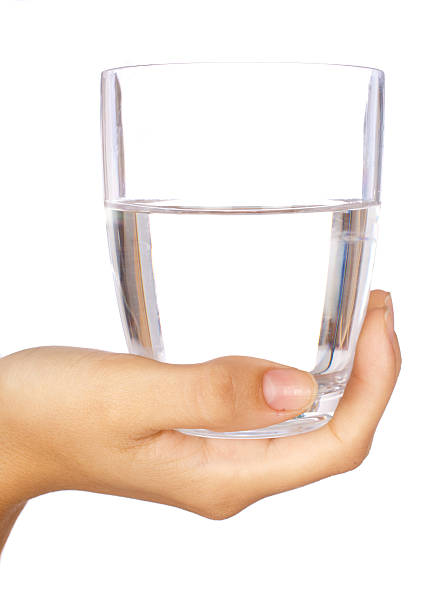 istock Hand holding a glass of water 489949550