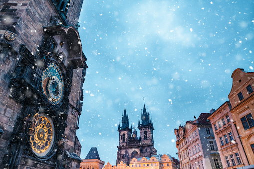 Astronomical Clock Tower on Old Town Square in Prague (Czech Republic, Europe) on a snowy winter evening.