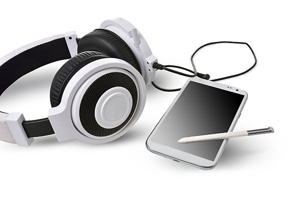 istock White headphones and smart phone on white background. 489952820