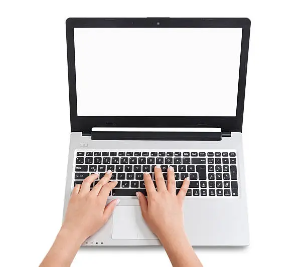 Caucasian woman typing on laptop computer. Screen is blank white. Photo's taken from directly above. Objects are isolated.
