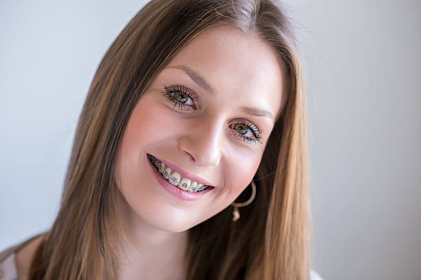 istock Smiling young woman with braces 489954096