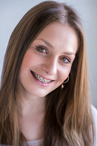istock Young woman with dental braces 489954222