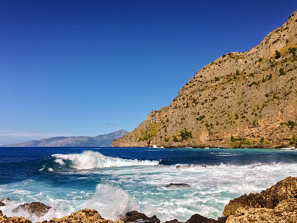 istock Cliffs near Maratea (southern Italy) and rough sea 489954952