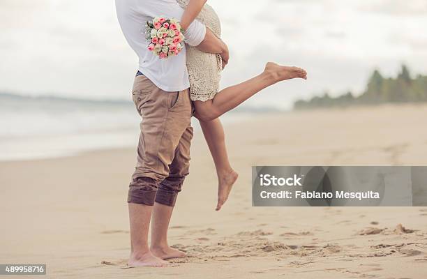 Bride And Groom On The Beach Stock Photo - Download Image Now - Beach, Wedding, Engagement