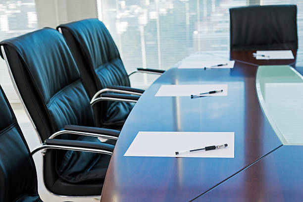 ready for a meeting Corporate boardroom with blank paper set for the meeting. shareholders meeting stock pictures, royalty-free photos & images