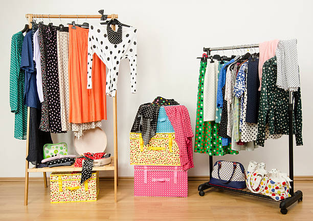 istock Dressing closet with polka dots clothes arranged on hangers. 489968169