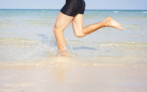 istock Deatail of man running on the beach 489968421