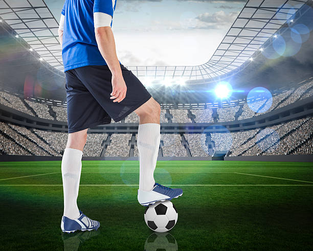 istock Football player standing with ball 489969873
