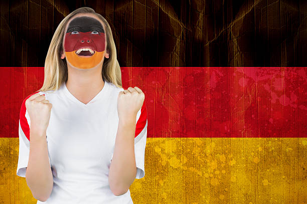 istock Excited german fan in face paint cheering 489970461