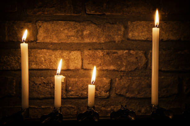 istock Candles Burning in Dark Church 489971983