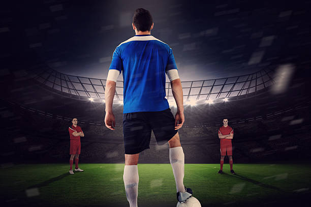 istock Handsome football player in blue jersey facing opposition 489973189