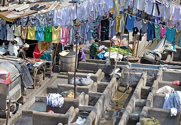 Mumbai, India - February 23, 2013:Dhobi Ghat (Mahalaxmi Dhobi Ghat) is a well known open air laundry in Mumbai, India. The washers, locally known as Dhobis, work in the open using these open tanks to wash the clothes from Mumbai's hotels and hospitals