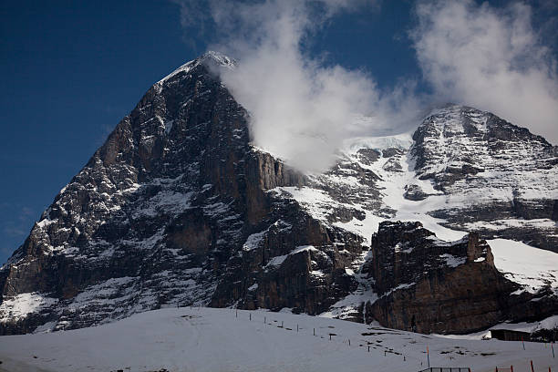 North Face Eiger cloud swirls over the mountain North Face of the Eiger cloud swirls over the mountain eiger northface stock pictures, royalty-free photos & images