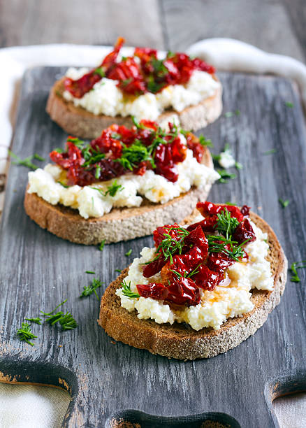 istock Bread slices with ricotta cheese and, sun dried tomatoes 489975612