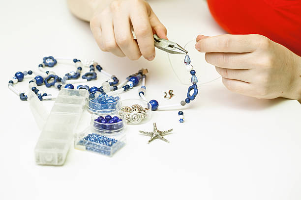 istock Woman making necklase from colorful plastic beads 489975631