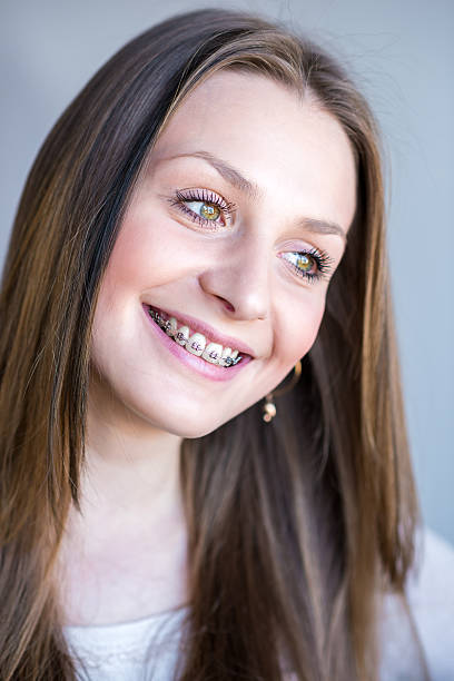 istock Young woman with dental braces 489975670