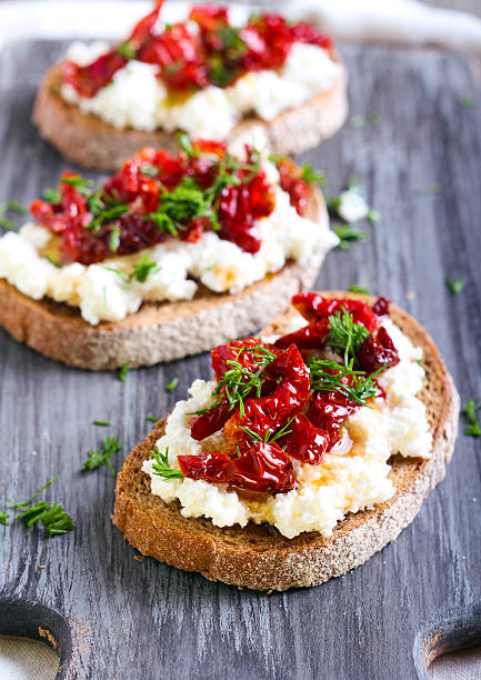 istock Bread slices with ricotta cheese and, sun dried tomatoes 489975694