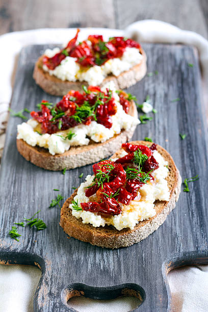 istock Bread slices with ricotta cheese and, sun dried tomatoes 489975768