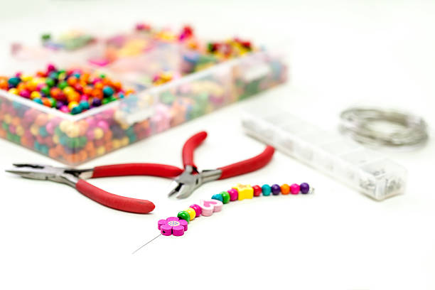 Bracelet made of plastic beads for girls unfinished in process stock photo