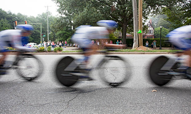 UCI Road World Championships Richmond, Virginia, United States- September 19, 2015: World class women riders wearing blue and white are a blur as they cycle through the Bellevue district in Richmond, Virginia during time trials at the UCI Road World Championships, Saturday September 19, 2015. uci road world championships stock pictures, royalty-free photos & images