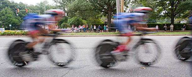 UCI Road World Championships Richmond, Virginia, United States- September 19, 2015: World class women riders wearing red, blue and white are a blur as they cycle through the Bellevue district in Richmond, Virginia during time trials at the UCI Road World Championships, Saturday September 19, 2015. uci road world championships stock pictures, royalty-free photos & images