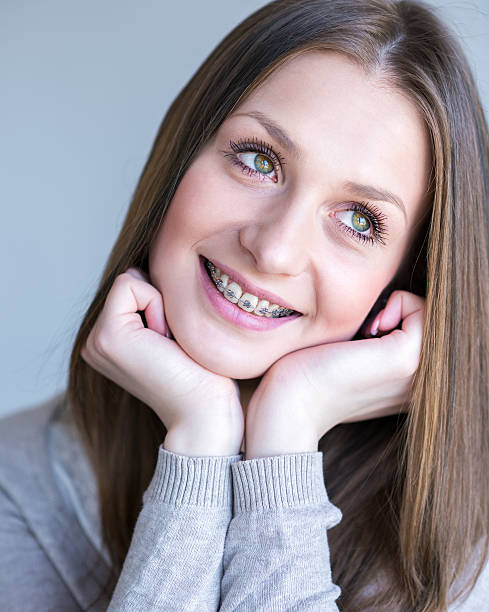 istock Young woman with dental braces 489977712