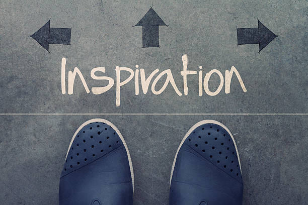 istock Hand drawn inspriration word on front of business man feet 489979026