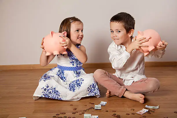 Photo of Children holding their piggy bank