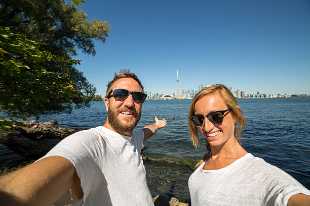 istock Young couple taking selfie portrait in Toronto-Summer 489980542