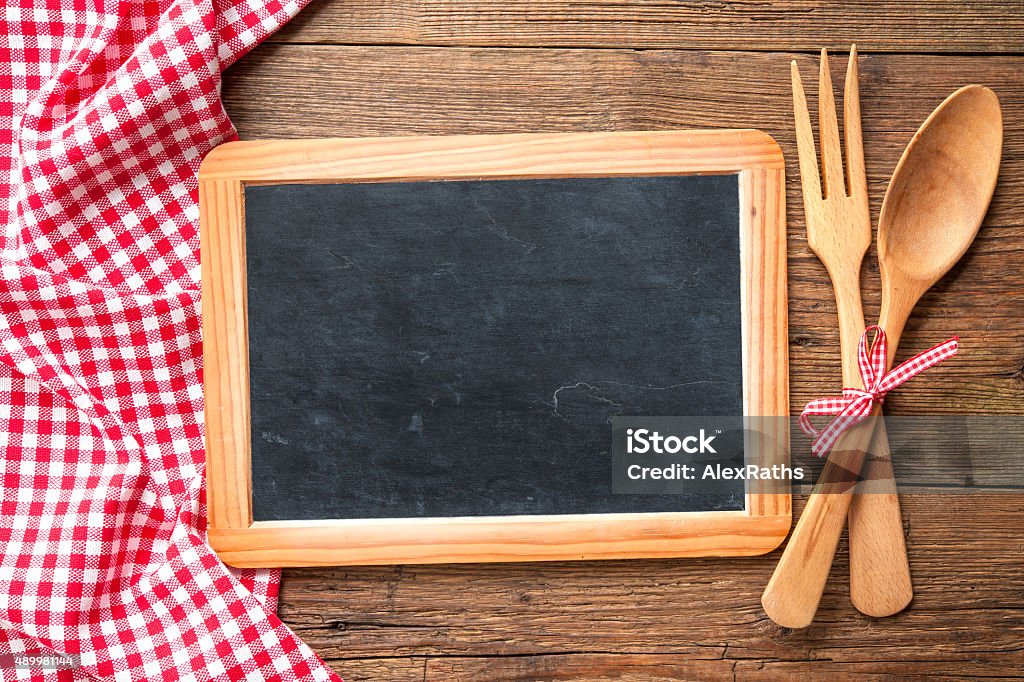 Blackboard with a red checkered tablecloth Kitchenware on a blackboard with a red checkered tablecloth 2015 Stock Photo