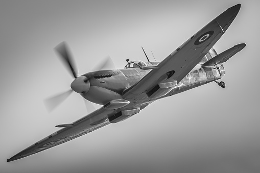Duxford, UK - September 20, 2015: a Spitfire Mk IX fighter aircraft of WWII in flight over Cambridgeshire, England. 