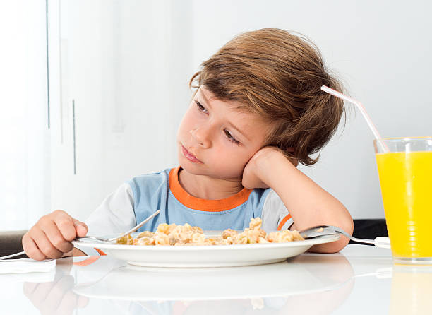 istock boy does not want to eat 489985060