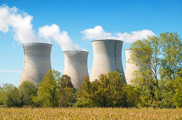 istock French nuclear power station with steaming cooling towers in field 489985126