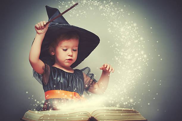 istock Halloween. cheerful little witch with a magic wand 489988776