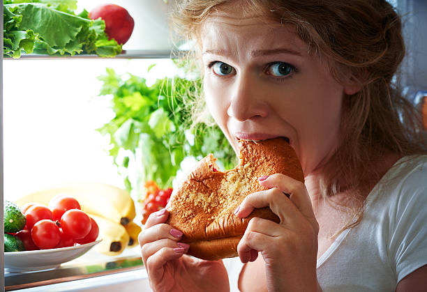 istock Woman eats night stole the refrigerator 489989066