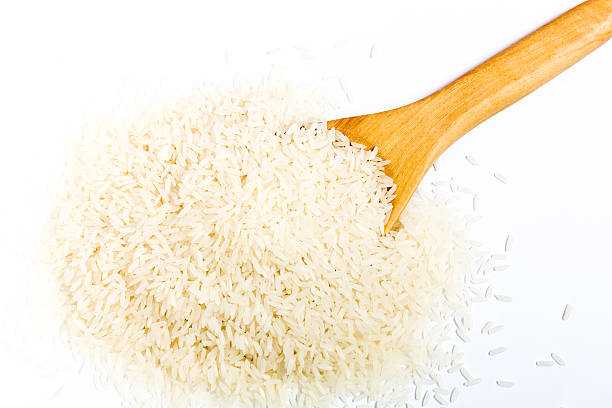 istock Rice with wood spoon on white background 489989380
