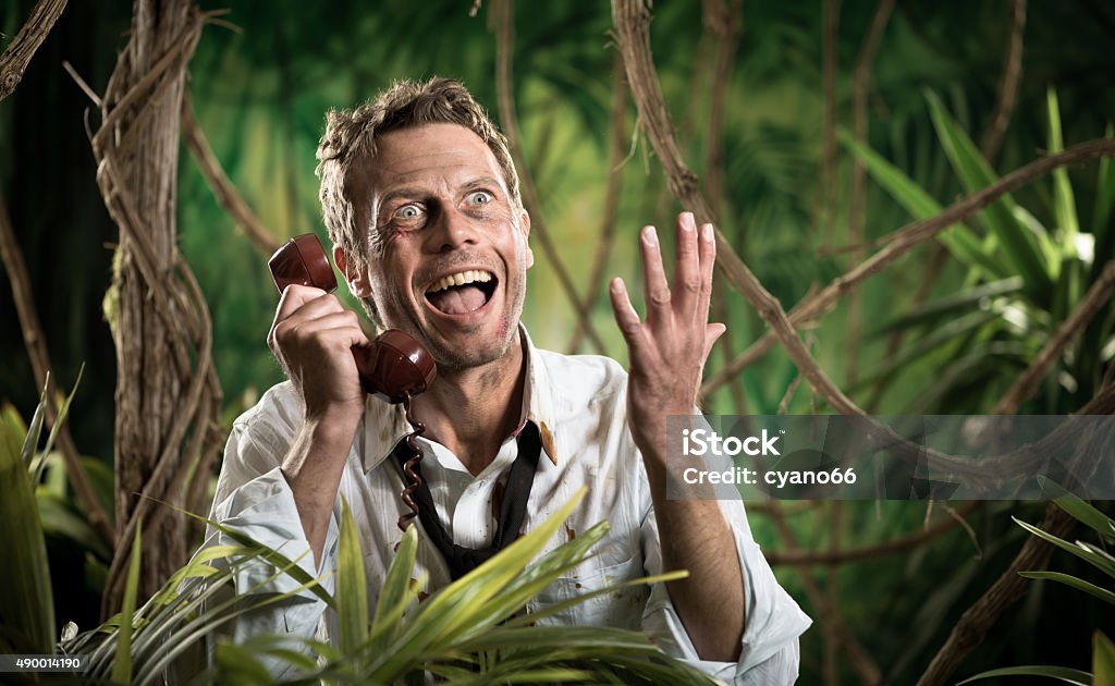 Furious businessman on the phone lost in the jungle Angry businessman lost in jungle screaming at the phone and gesturing. Distraught Stock Photo