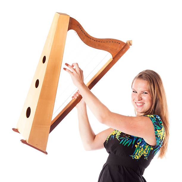 istock young caucasian woman plays small harp in studio 490014422