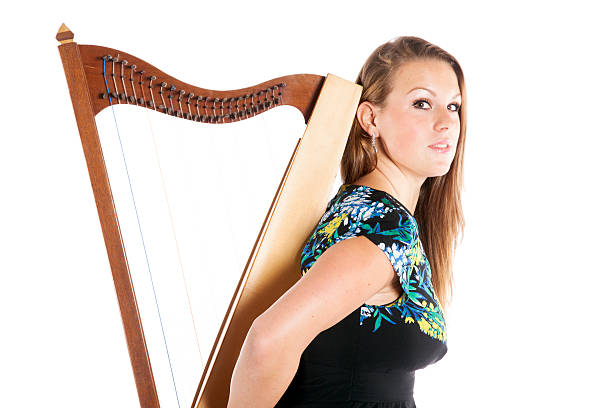 istock young caucasian woman with small harp in studio 490014458